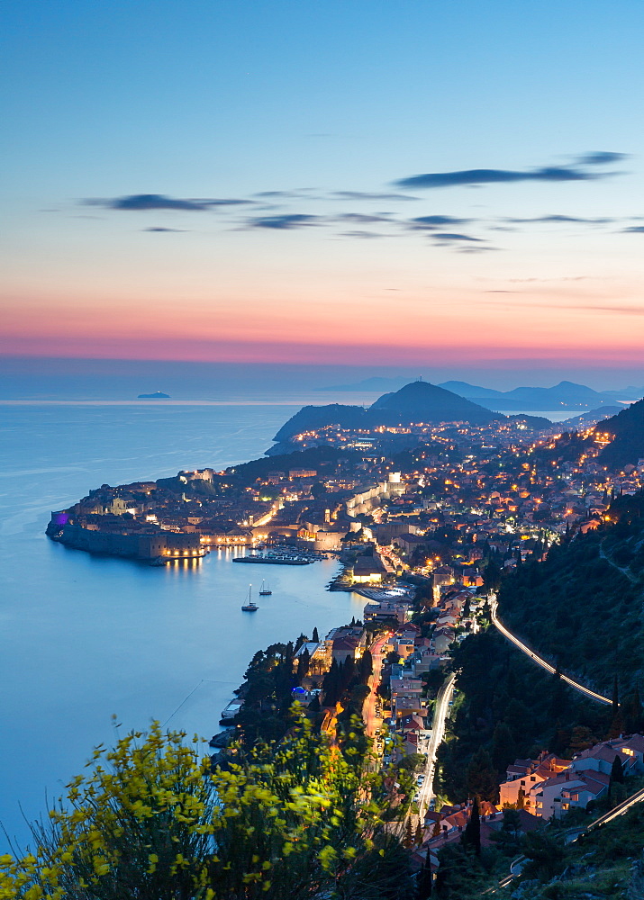 The city lights at sunset over the old town of Dubrovnik, UNESCO World Heritage Site, and the Dalmatian Coast, Croatia, Europe