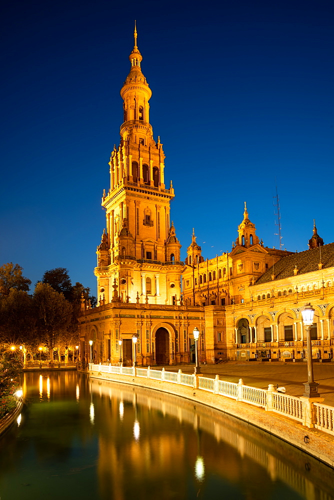 The North Tower of Plaza de Espana lit up at night, Parque de Maria Luisa, Seville, Andalusia, Spain, Europe