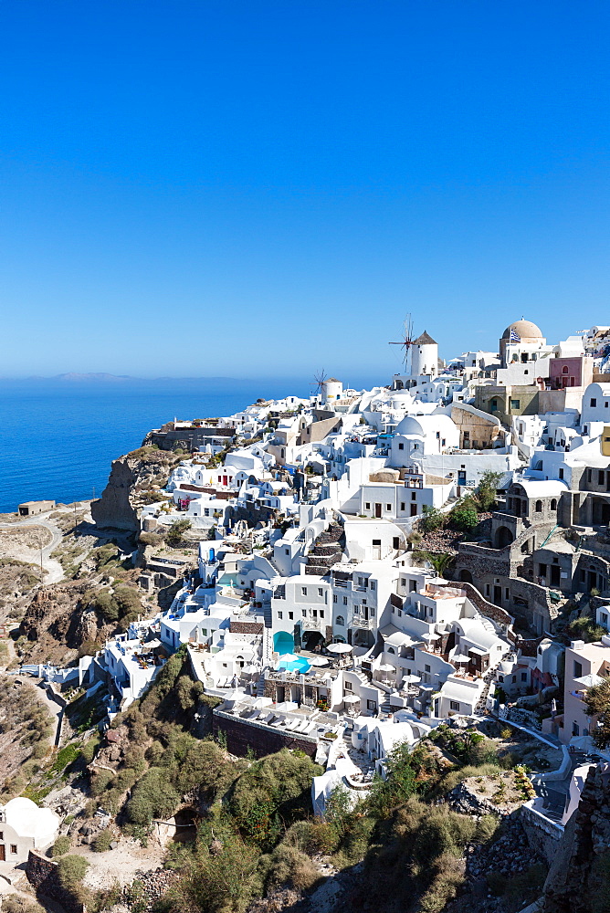 Day time view over the whitewashed buildings and windmill of Oia from the castle walls, Santorini, Cyclades, Greek Islands, Greece, Europe