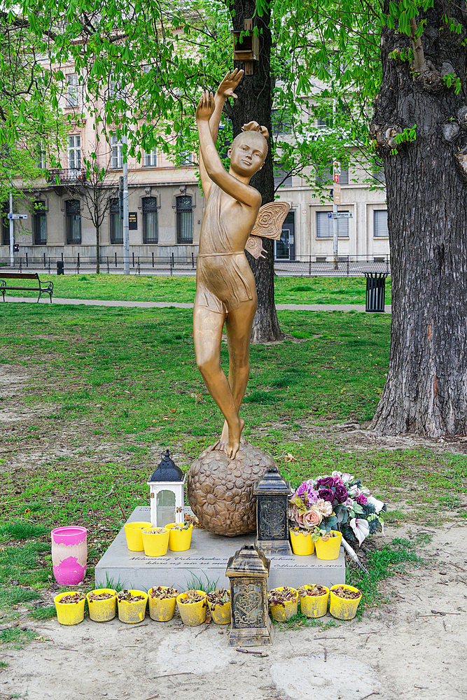 Bronze Statue depicting a young butterfly girl with raised hands at a park in Bratislava, Slovakia, Europe