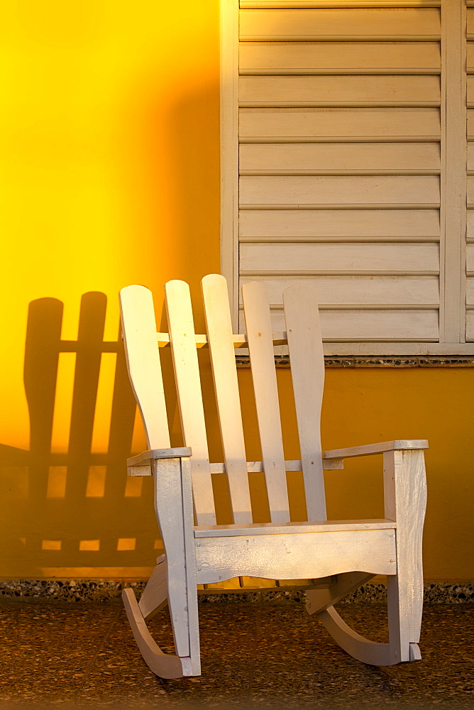 White rocking chair on yellow porch, Vinales, UNESCO World Heritage Site, Cuba, West Indies, Caribbean, Central America