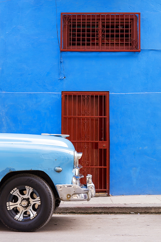 Front of old vintage car parked in front of blue building, Havana, Cuba, West Indies, Caribbean, Central America