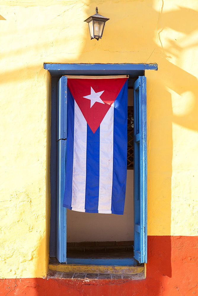 Cuban Flag in doorway, Trinidad, UNESCO World Heritage Site, Sancti Spiritus, Cuba, West Indies, Caribbean, Central America