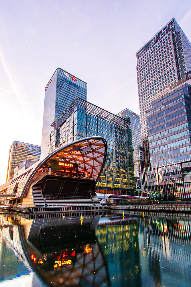 Crossrail station and office buildings reflecting in dock before sunrise, Canary Wharf, Docklands, London, England, United Kingdom, Europe