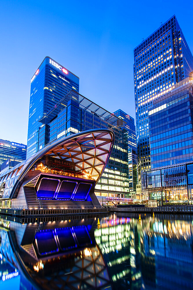 Crossrail station and office buildings reflecting in dock before sunrise, Canary Wharf, Docklands, London, England, United Kingdom, Europe