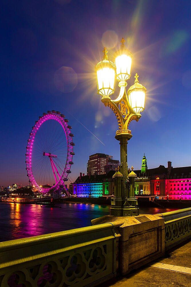 Lamp on Westminster Bridge with London Eye and London Aquarium in background at sunrise, London, England, United Kingdom, Europe