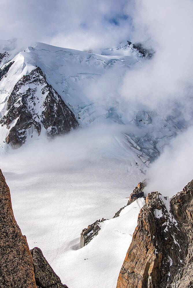 Looking down to the Vallee Blanche and the Cosmiques Hut used by climbers on Mont Blanc, small figures are seen in the valley, Chamonix, Haute Savoie, Rhone Alpes, France, Europe