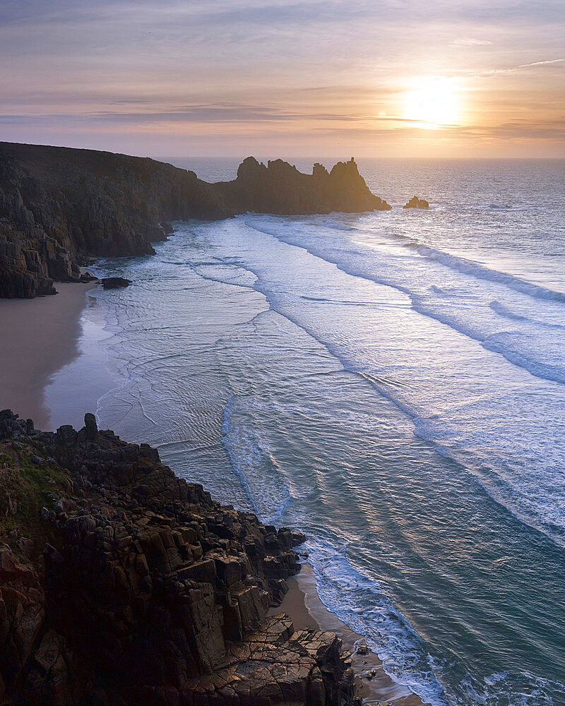 Sunrise over the beautiful and secluded beach at Pedn Vounder overlooking Logan Rock, near Porthcurno, Cornwall, England, United Kingdom, Europe