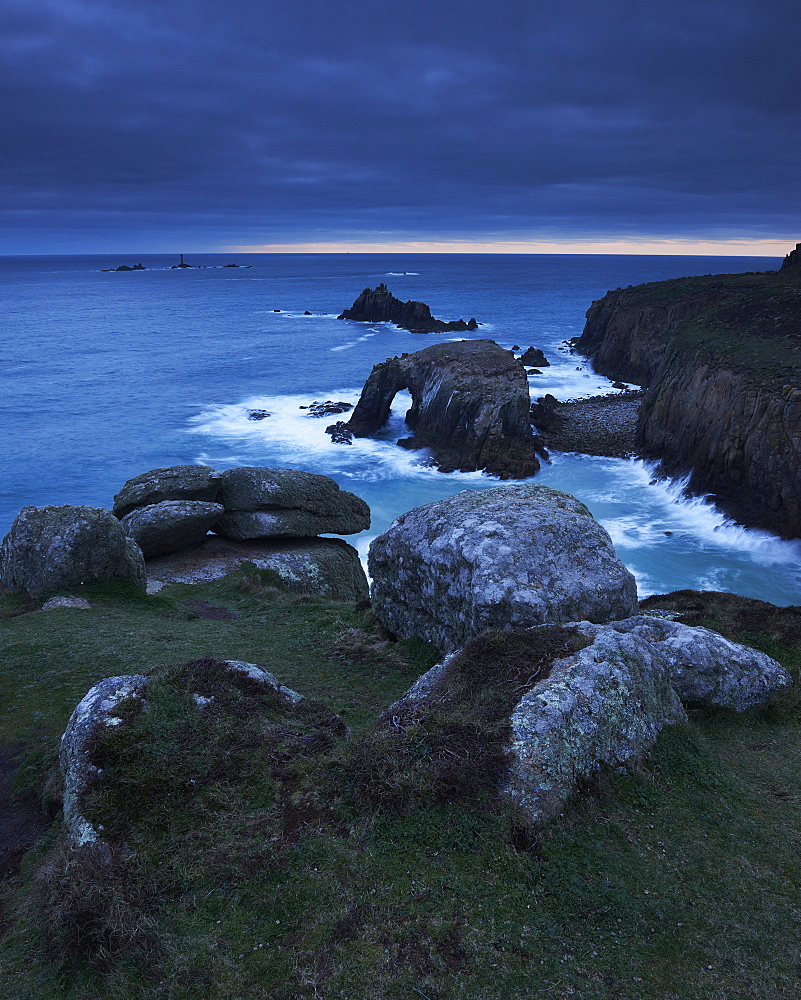 Sunset at Land's End over Enys Dodman rock arch, Longships Lighthouse, Cornwall, England, United Kingdom, Europe