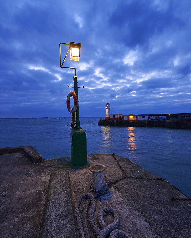 Lights at end of harbour walls in twilight, Newlyn, Cornwall, England, United Kingdom, Europe