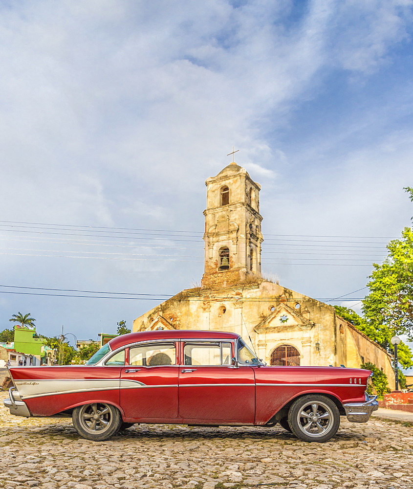 A vintage American car parked outside the Church of Santa Ana, Trinidad, UNESCO World Heritage Site, Cuba, West Indies, Caribbean, Central America