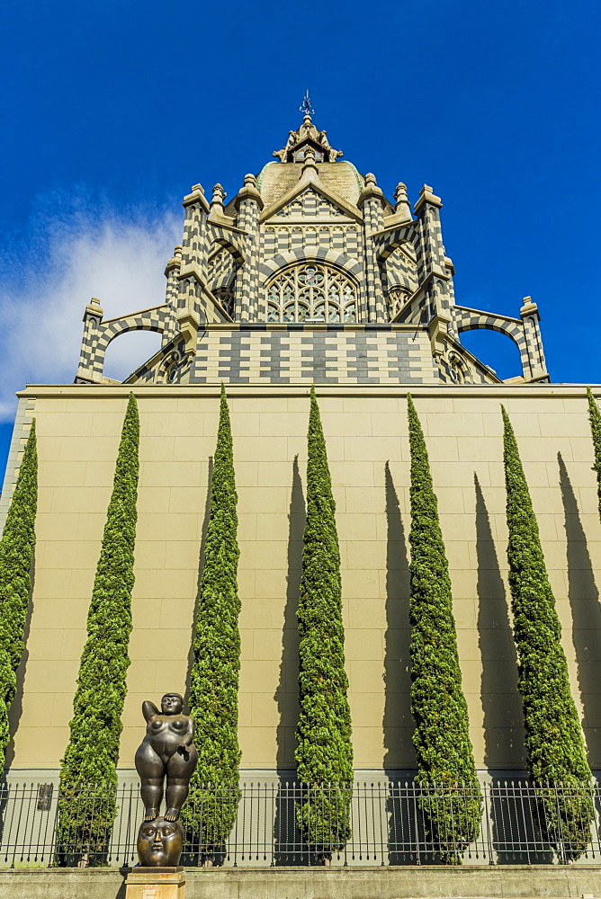 A view of the Rafael Uribe Uribe Palace of Culture with the Fernando Botero statue Pensamiento (Thought) in the foreground, Medellin, Colombia, South America