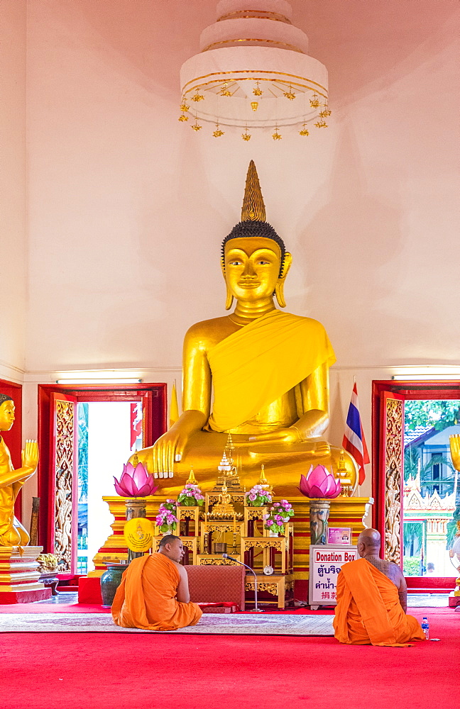 Monks in Mongkol Nimit temple (Wat) in Phuket old town, Phuket, Thailand, Southeast Asia, Asia