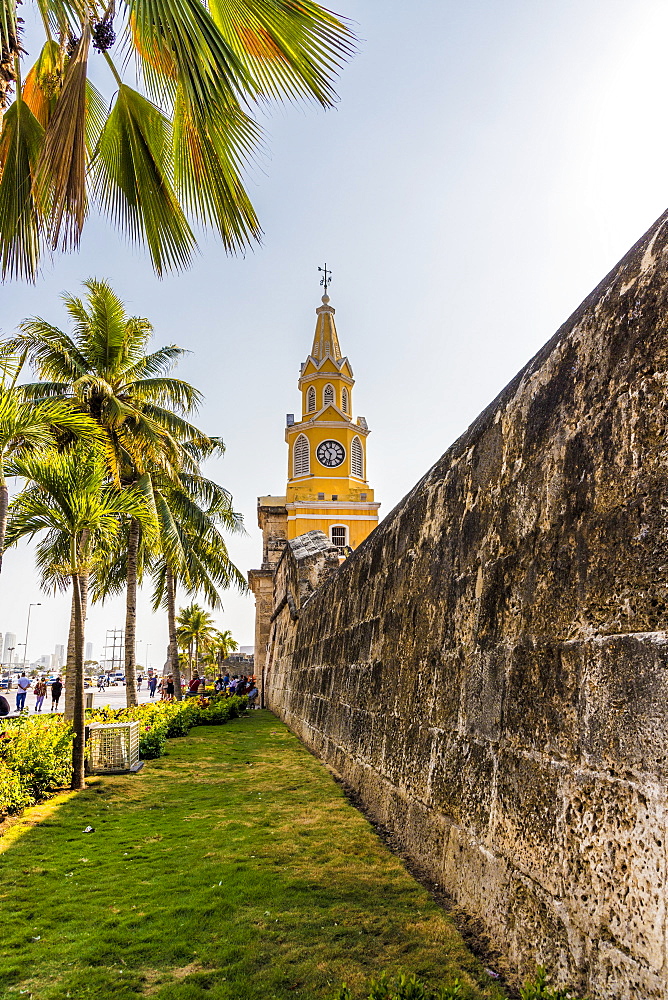 The colourful clock tower (torre del reloj) along the ancient city walls in Cartagena de Indias, Colombia, South America