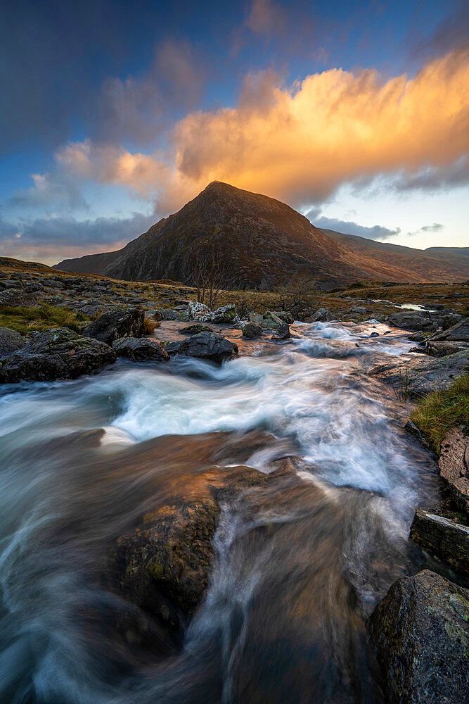 View of Tryfan with flowing river in Snowdonia National Park. Ogwen, Conwy, Wales