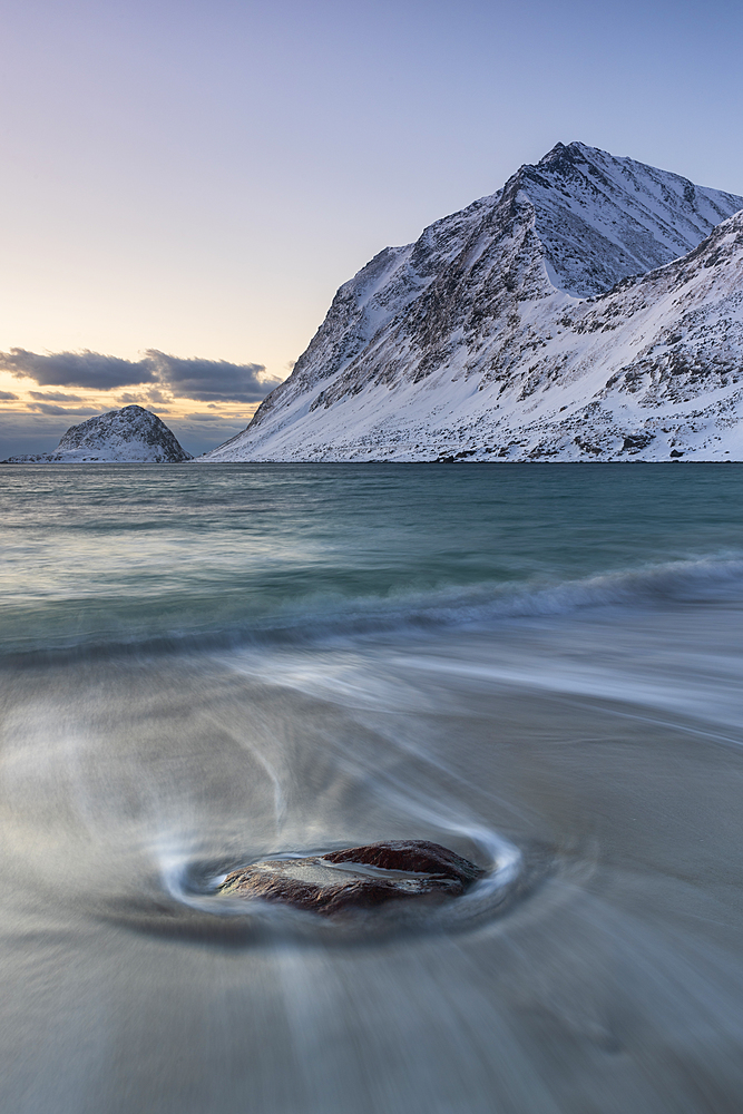 Solitary stone on Haukland Beach in winter, Lofoten, Nordland, Arctic, Norway, Europe