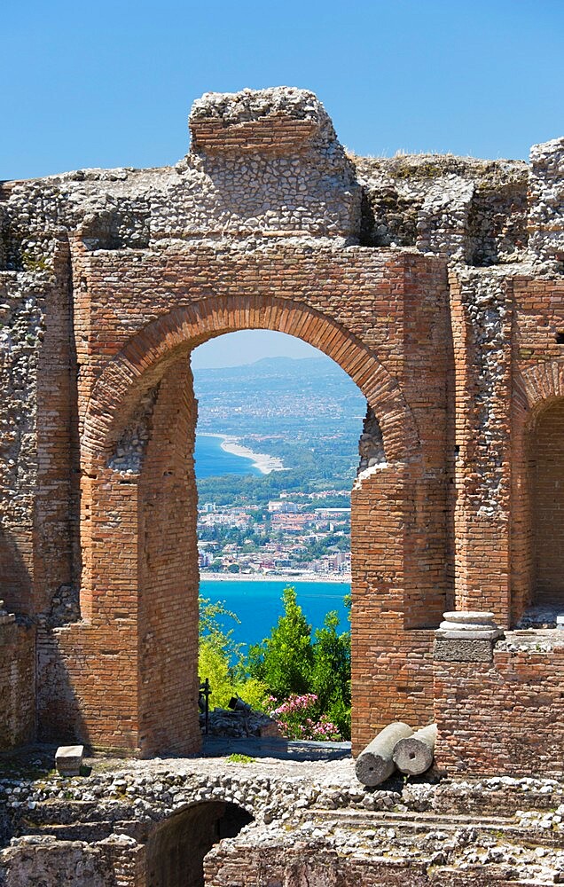 View from the Greek Theatre through arch to the Bay of Naxos, Taormina, Messina, Sicily, Italy, Mediterranean, Europe