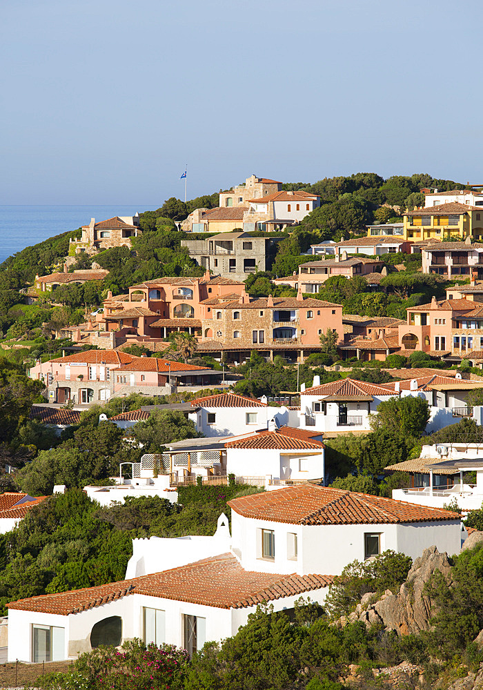 View over tiled rooftops to houses clinging to rocky hillside, Porto Cervo, Arzachena, Sassari, Sardinia, Italy, Mediterranean, Europe