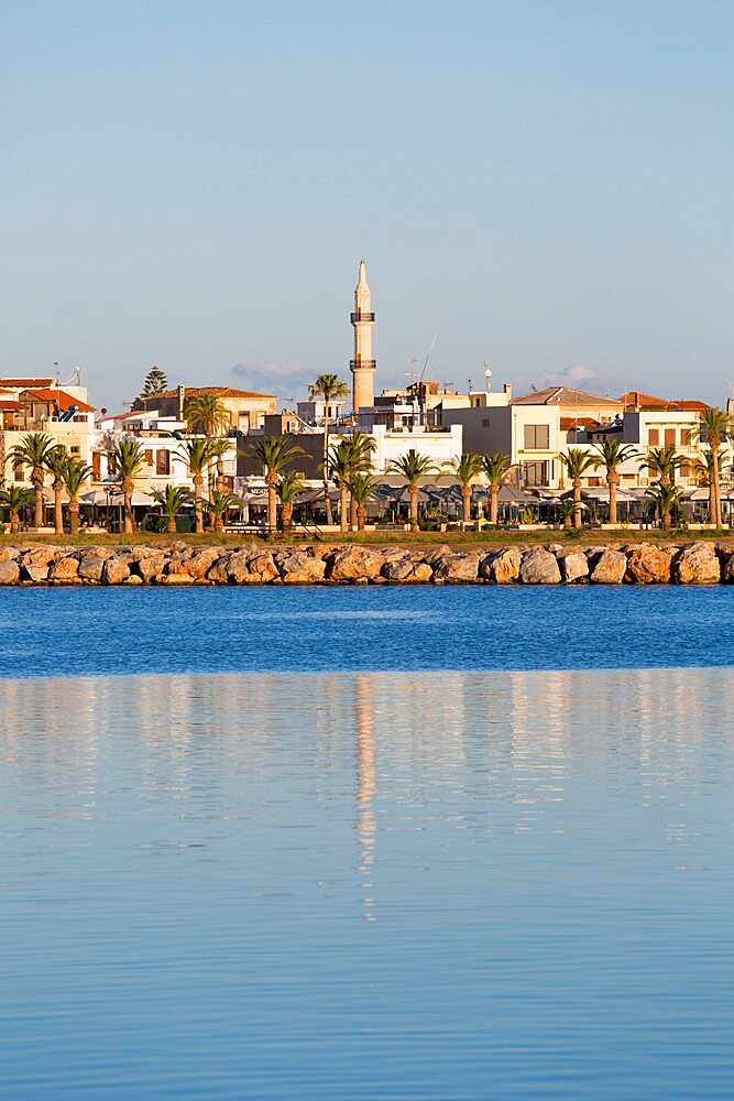 View to the waterfront, early morning, minaret of the Neratzes Mosque reflected in water, Rethymno (Rethymnon), Crete, Greek Islands, Greece, Europe