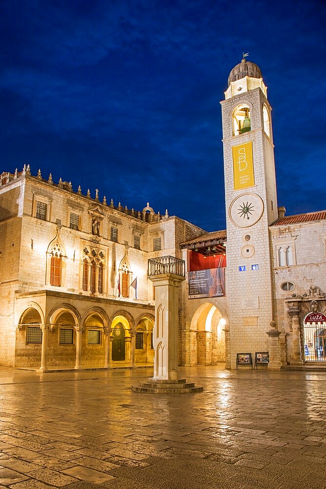 View across marble-paved Luza Square to the Sponza Palace and clock tower, dusk, Dubrovnik, Dubrovnik-Neretva, Dalmatia, Croatia, Europe