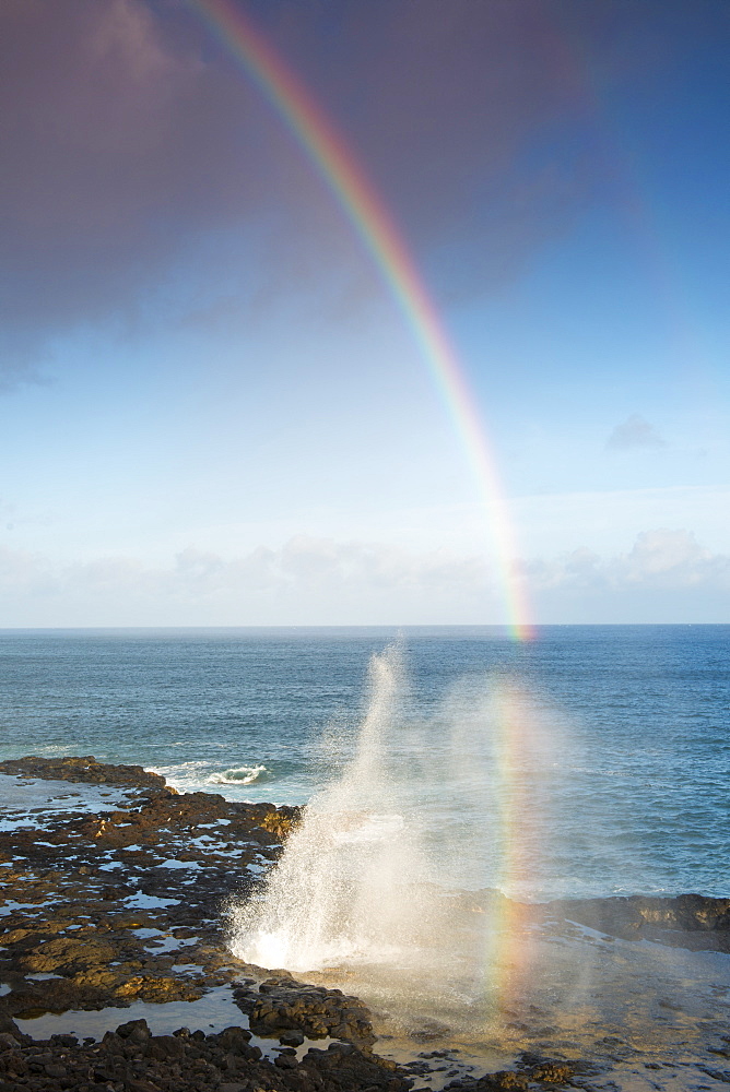 Spouting Horn with a morning rainbow, on the south coast of Kauai near Poipu, Kauai, Hawaii, United States of America, North America