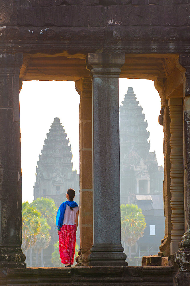 A tourist gazing out at Angkor archaeological complex, UNESCO World Heritage Site, Siem Reap, Cambodia, Indochina, Southeast Asia, Asia