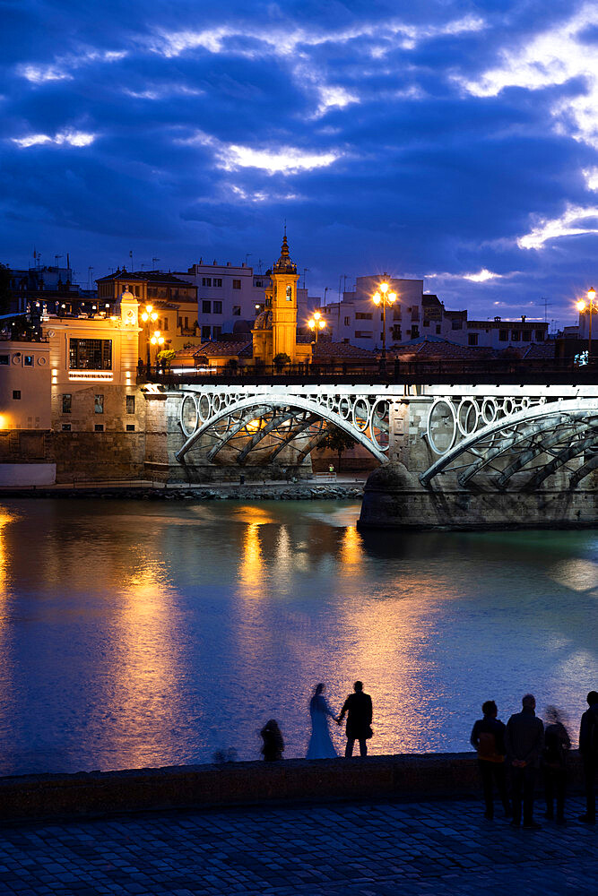 The Triana Bridge (Puente de Triana) (Puente de Isabelle II) in Seville at twilight, Seville, Andalucia, Spain, Europe