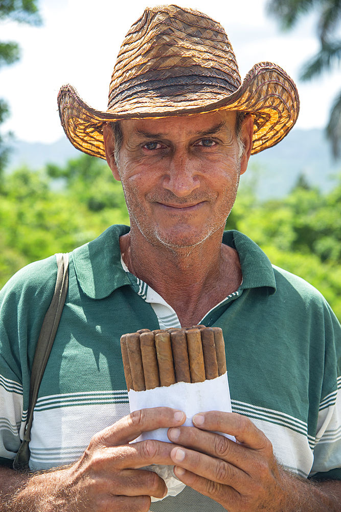 Local man selling Cuban cigars in Vinales, Cuba, West Indies, Caribbean, Central America