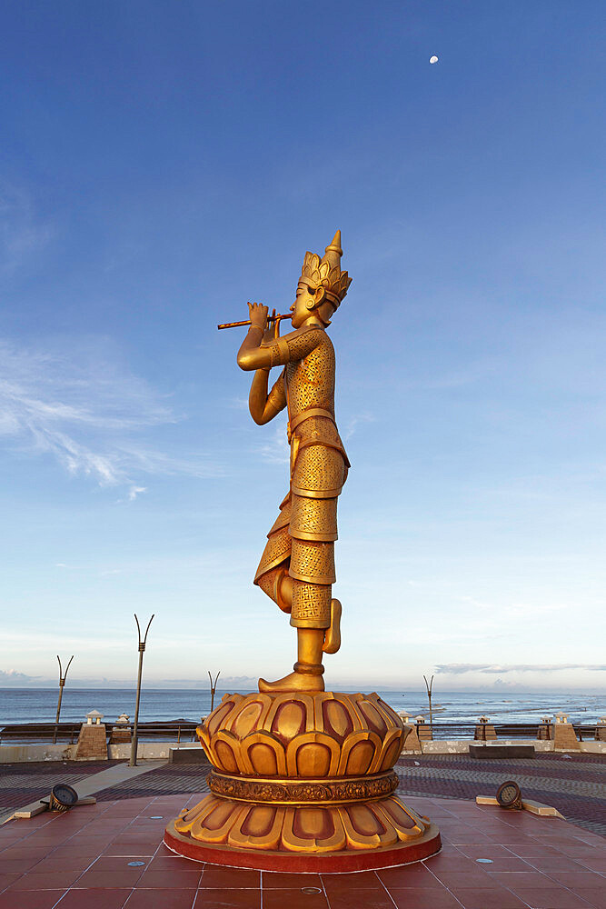 Portrait view of the Rakhine Nyut Phu statue, with the sea in the background and a third-quarter moon in the sky, Sittwe, Rakhine, Myanmar (Burma), Asia