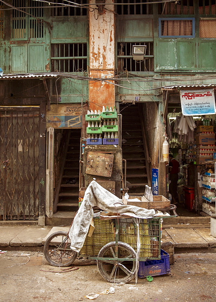 An old drinks cart outside an old building in Chinatown, Yangon (Rangoon), Myanmar (Burma), Asia