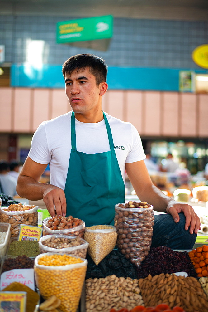 A seller in Zelenyy Bazar (Green bazaar), a farmer's market with stalls selling meat, vegetables and dried fruits, Almaty, Kazakhstan, Central Asia, Asia