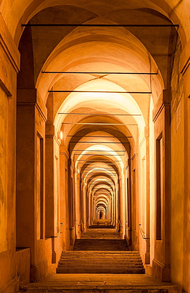 The porticoes of Bologna, the longest in the world, night view of the arches towards the San Luca church, Bologna, Emilia Romagna, Italy, Europe