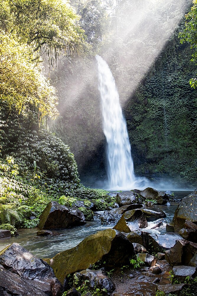 Waterfall in the jungle with sunbeams from the top, Bali, Indonesia, Southeast Asia, Asia