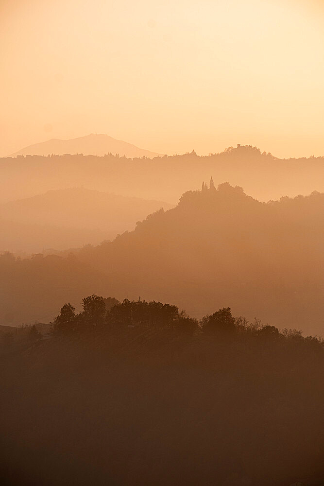 Sunset light reflected in the mist on countryside hills, Emilia Romagna, Italy, Europe