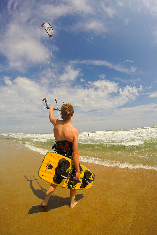 A kiteboarder heads out into the Atlantic Ocean off Cape Hatteras, North Carolina, United States of America, North America