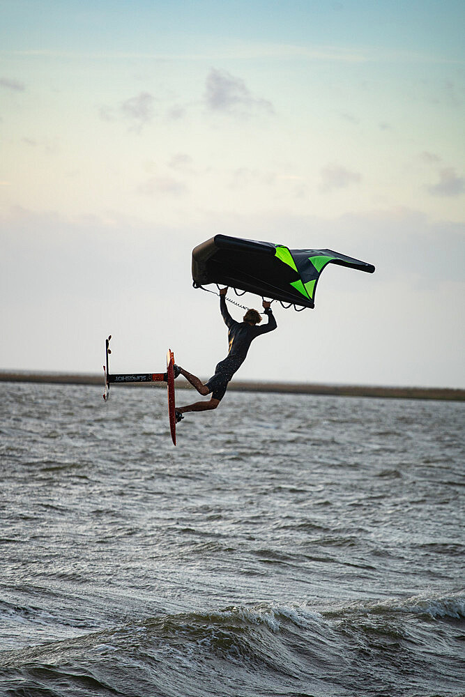 Pro surfer James Jenkins jumps his wing surfer over the Pamlico Sound at Nags Head, North Carolina, United States of America, North America