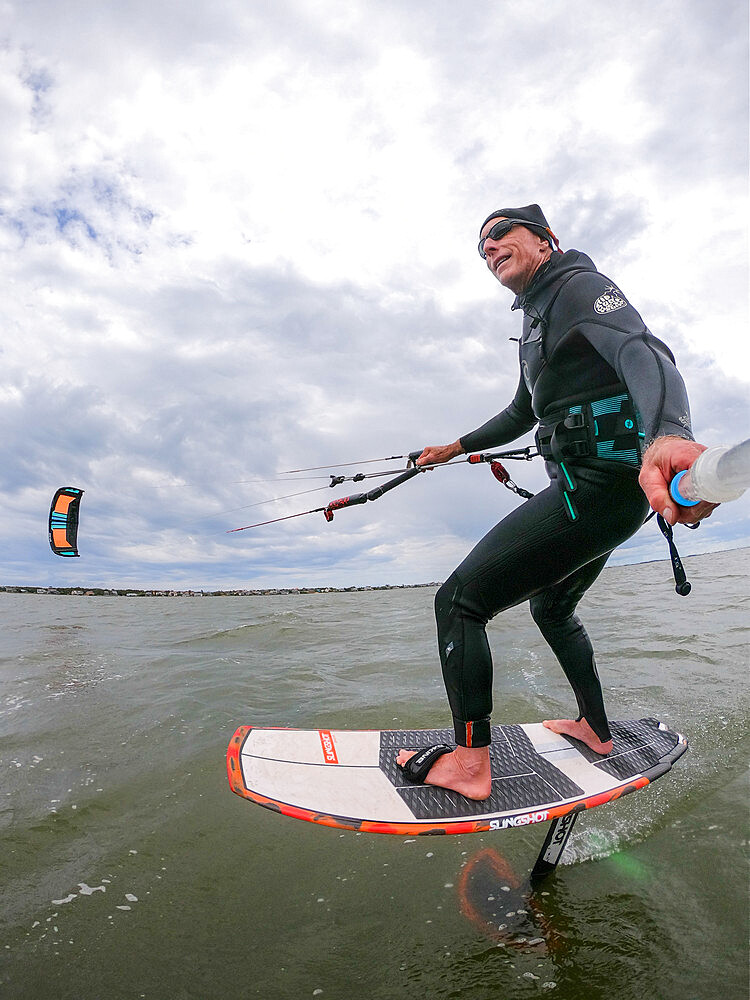 Photographer Skip Brown on his foiling kiteboard on the Pamlico Sound, Nags Head, North Carolina, United States of America, North America