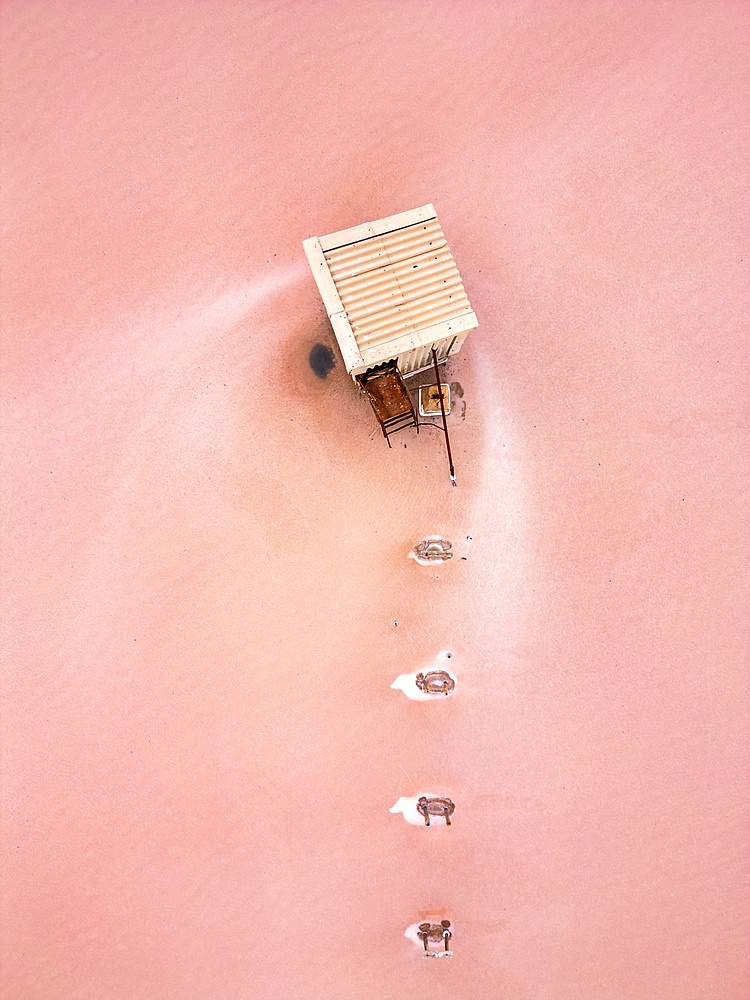 Tuz salt lake drone aerial view of house in the lake with pink salt around, in Turkey