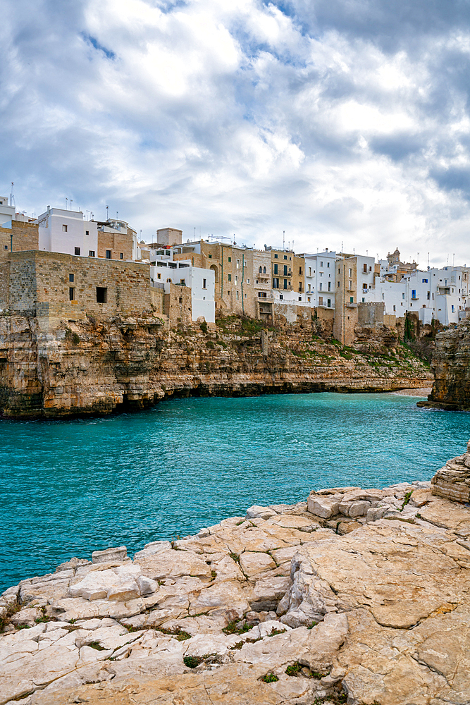 Polignano a Mare historic coastal city with traditional houses on the adriatic sea cliffs with turquoise water, in Italy