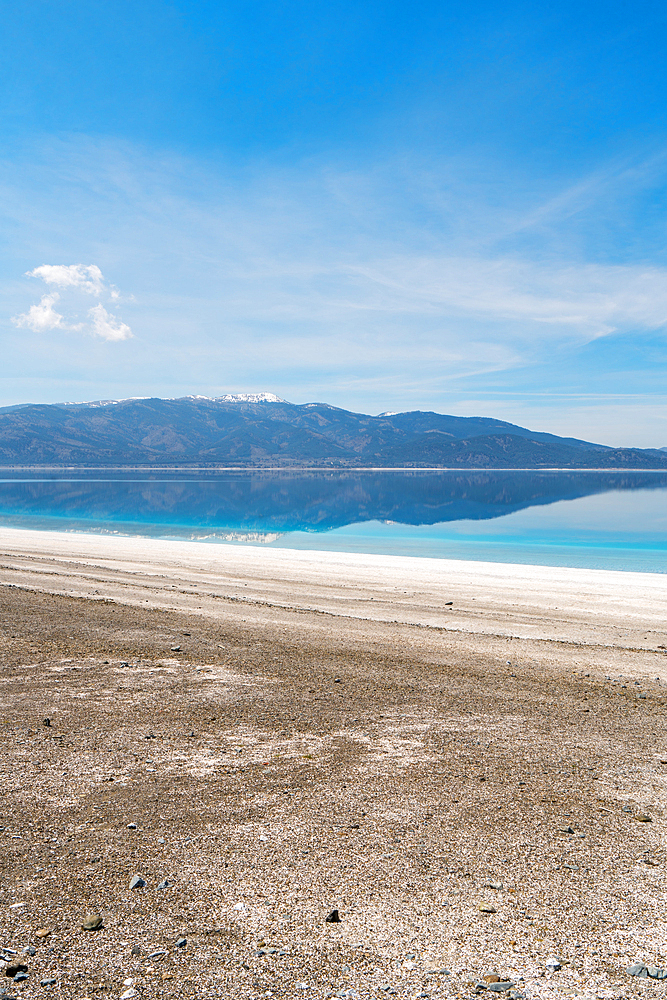 Salda lake with turquoise water and white sand and mountains at sunset in Turkey
