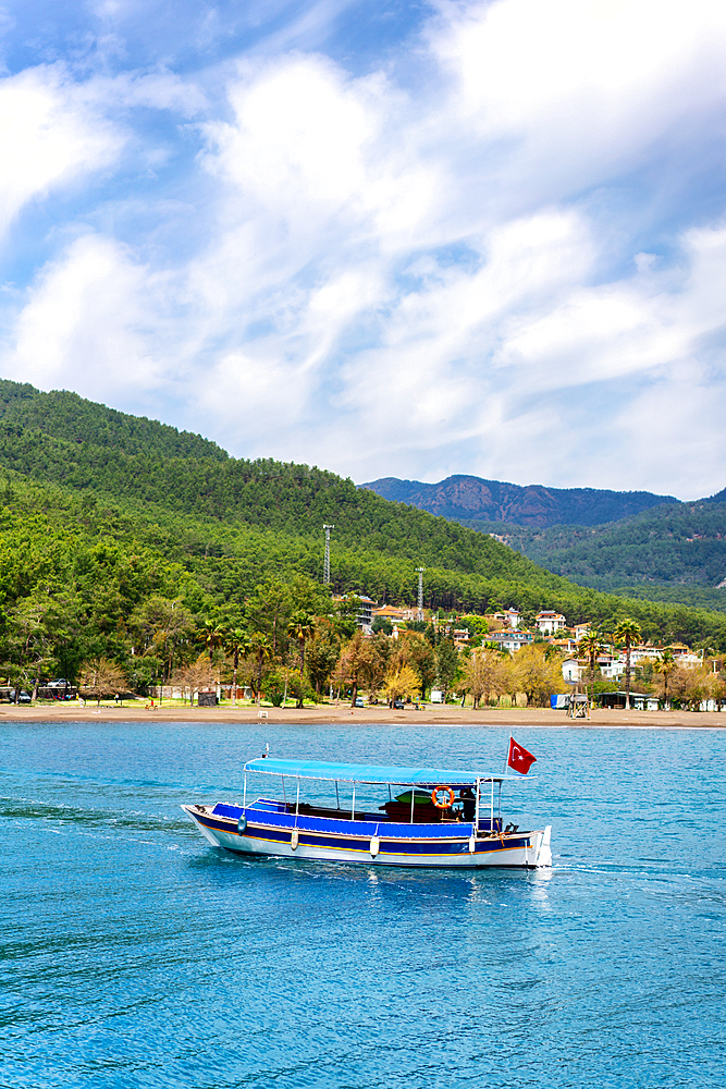 Tourist boa in the turquoise water of Ekincik in Turkey