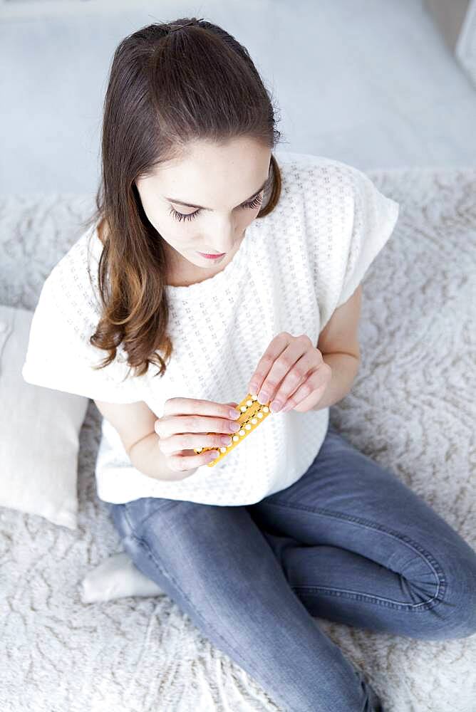 Woman taking contraceptive pill.