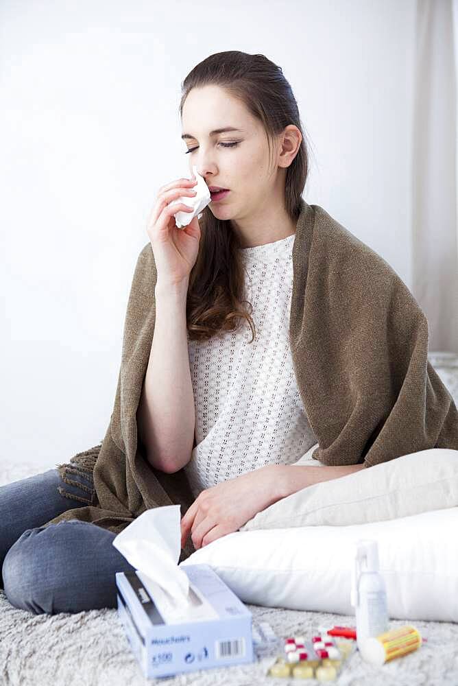 Woman blowing her nose.