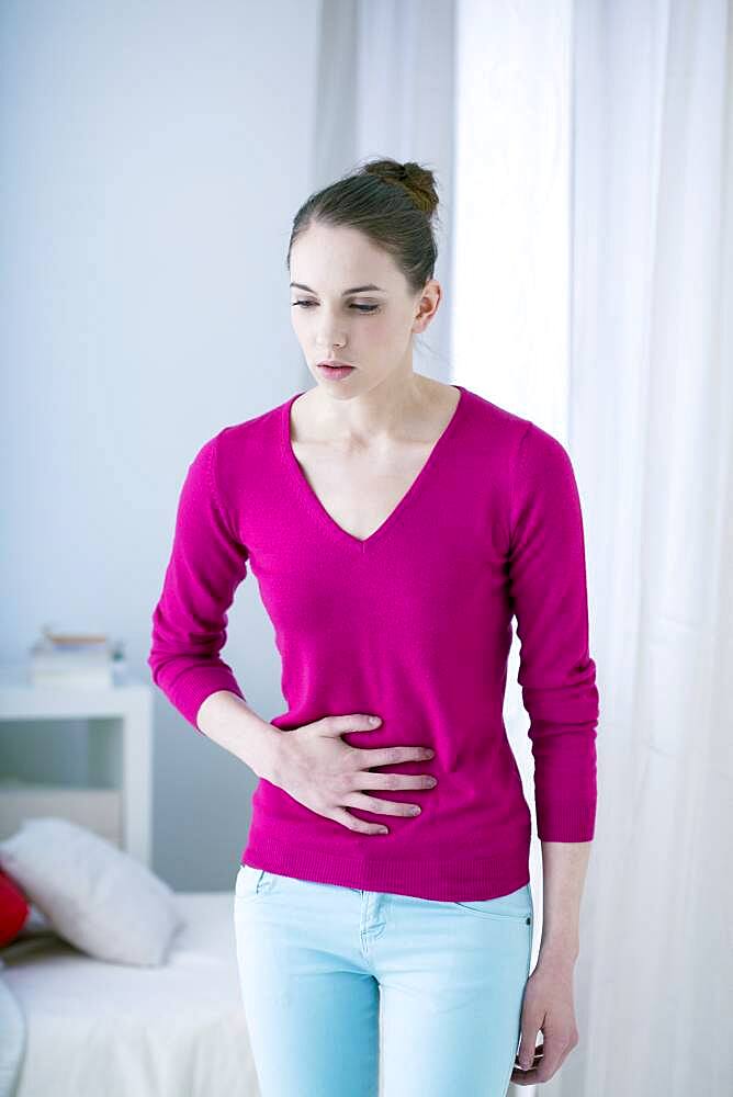 Woman suffering from abdominal pain.