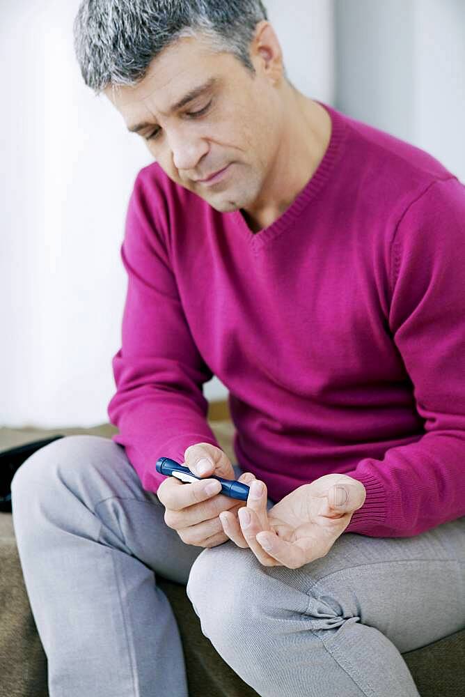 Man checking his blood glucose level.