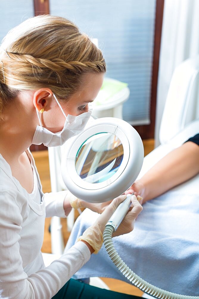 Woman receiving podiatry treatment in Day Spa.