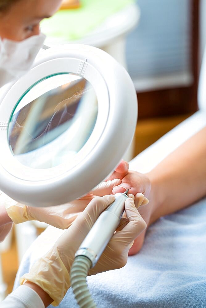 Woman receiving podiatry treatment in Day Spa.