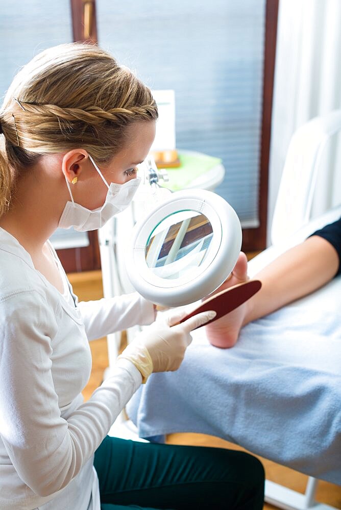 Woman receiving podiatry treatment in a Day Spa.