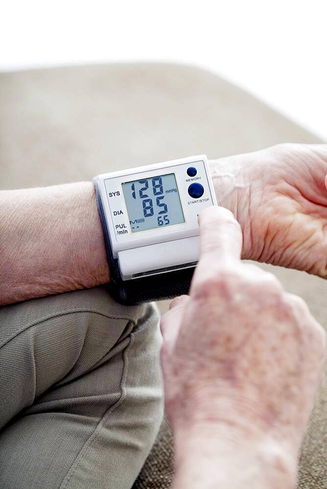 Senior woman measuring her blood pressure.