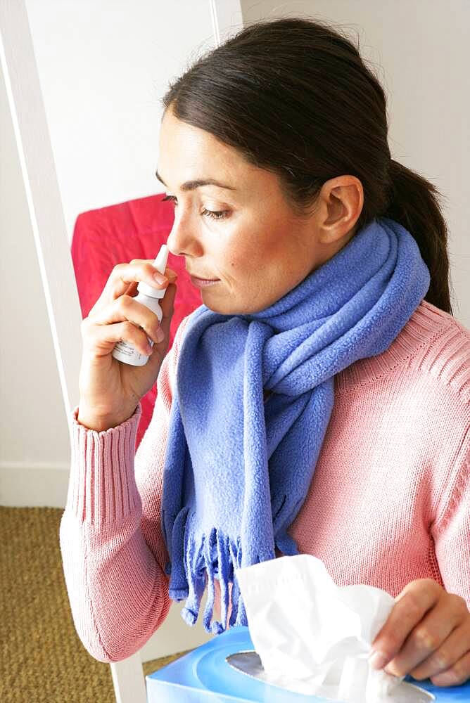 Woman using nose spray